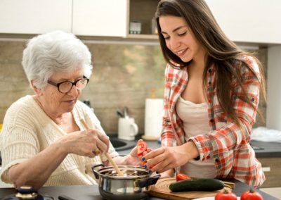 Grandmother and granddaughter cooking in the kitchen.